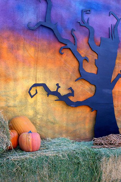 Fall Photo Backdrop: spooky back drop with blackish purple spooky tree and orange and yellow darkened sky; bail of straw and pumpkins at the forefront. Good for fall or Halloween party (don't forget some bats!):) Fall Photo Booth, Veselý Halloween, Fall Backdrops, Halloween Photo Booth, Fall Carnival, Halloween Dance, Halloween Backdrop, Halloween Photo, Adult Halloween Party