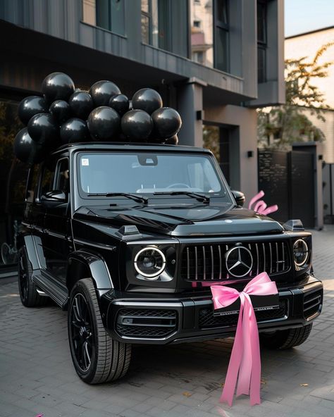 Embrace the elegance of celebration with this breathtaking scene featuring a luxurious black Mercedes-Benz G-Class. Adorned with a charming pink bow and surrounded by sleek black balloons, it's a vision of sophistication. ✨Don't forget to save and follow for more captivating visuals!👉 #LuxuryLifestyle #CelebrationVibes #MercedesBenzGClass #BlackAndPinkElegance #CarGoals #Aesthetic #AIImage Mercedes Black Car, Black G Wagon Pink Interior, Cars For Teenagers Black, G Wagon Gift, Pink G Wagon Aesthetic, Mercedes G Class Aesthetic, All Black G Wagon, Mercedes Benz G Class Black, Mercedes G Wagon Black
