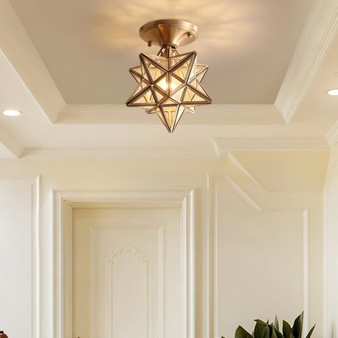 The Brass and Glass Pentagram Ceiling Light is an exquisite interior lighting decoration renowned for its distinctive design and high-quality materials. Crafted from premium brass, this ceiling light boasts durability while exuding a classical and elegant aesthetic. At its core, the light features an intricate glass pentagram that radiates a warm and gentle glow when light passes through, creating a comfortable ambiance indoors. 
 STANDARD SIZE (PICTURED) 
 Size:Dia 20cm x H 23cm /  7.9 x H 9