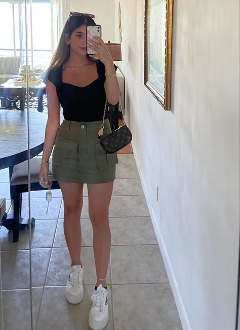 Green Skirt Black Top, Kakhi Skirt Outfit Summer, Mini Green Cargo Skirt Outfit, Cargo Skirt Green Outfit, Green Skirt And Black Top Outfit, Mini Skirt Top Outfit, Green And Black Skirt Outfits, Fits With Cargo Skirt, Black Top Green Skirt Outfit