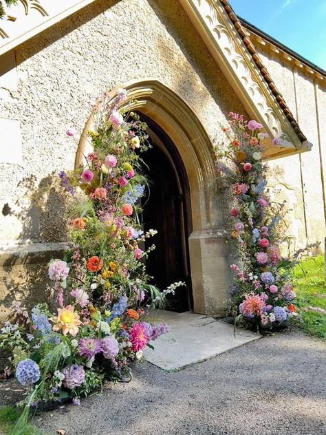 a large abundant floral archway at a church entrance created with colourful and elegant summer blooms Entrance Flowers, Colourful Wedding Flowers, Flower Archway, Floral Mechanics, Summer Wedding Floral, Church Entrance, Pastel Wedding Colors, Wildflower Wedding Theme, Wedding Church Decor