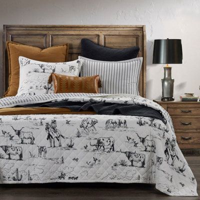 A playful Western take on traditional Toile de Jouy, our Reversible Quilt takes you on a heritage journey through the American frontier, replete with the natural scenery of wrangling cowboys, grazing cow herds, and frolicking desert wildlife. Its versatile black-and-white colorway lends a clean, modern look, juxtaposed with ticking stripes for a vintage feel. Suitable for both modern and traditional Western interiors, Lanty transforms into a rich rustic ensemble when mixed with the earth tones a Western Bed, Western Comforter, King Size Quilt Sets, Grazing Cow, Western Ideas, Desert Wildlife, Western Interior, Western Bedroom Decor, Western Bedding