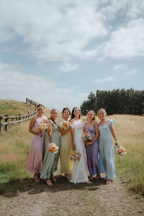 Different Colour Bridesmaid Dresses Pastel, Speing Bridesmaid Dresses, Bridesmaids Same Dress Different Colors, Wildflower Wedding Dresses, Wedding Dresses Garden Outdoor, Colorful Pastel Bridesmaid Dresses, Different Pastel Bridesmaid Dresses, Bridesmaid Dress Multi Color, Colourful Groomsmen Attire