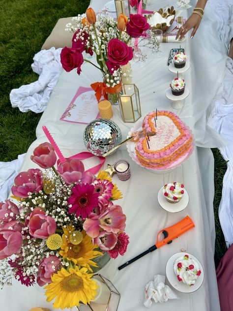 midsummer, backyard party, flowers, backyard lights, candles, birthday party, aesthetic, summer, summer bucket list, pink, orange, pink and orange, disco balls, cupcakes, cake, heart shaped cake, aesthetic cake, table layout Heart Themed Birthday, 18th Birthday Party Themes, Sunset Party, Flower Birthday Party, Backyard Birthday Parties, Orange Birthday, Picnic Birthday Party, Backyard Birthday, Birthday Dinner Party