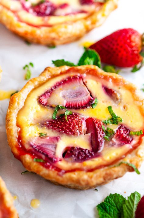 Strawberry Honey Custard Tarts with Lemon Curd - A yogurt based custard sweetened with honey and fresh strawberries in a flaky, golden pie crust and then topped with a drizzle of homemade lemon curd. From aberdeenskitchen.com #strawberry #honey #custard #tart #lemon #curd #spring #summer #easter #dessert #baking #recipe Custard Tart, Strawberry Tart, Strawberry Tarts, Strawberry Honey, Homemade Lemon Curd, Custard Tarts, Dessert Baking, Baking Recipe, حلويات صحية