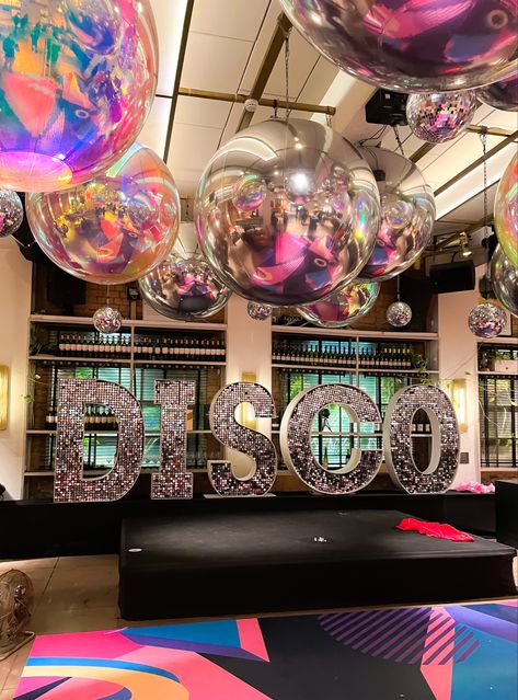 Amazing disco party theme party with disco shimmer letters and giant mirror balls . Decor by Dna. Letters by Big love letters . Disco Party Ceiling Decorations, Disco Float Ideas, Big Party Theme Ideas, Disco Theme Homecoming Float, Mirror Theme Decor, Disco Balls Decoration, 90s Disco Theme Party, Disco Night Decoration, Retro Prom Decorations