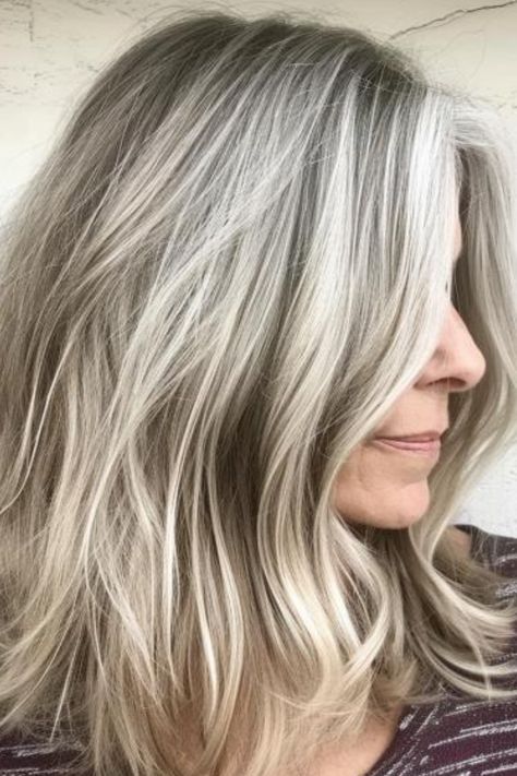 Sandy blonde is a light, muted shade that blends beautifully with gray hair, creating a soft, beachy look. Use a gentle, nourishing shampoo to keep it looking fresh. Click here to check out more where experts and women agree that these colors are perfect or gray hair. Grey Frosted Hair, Transition Grey Hair With Highlights, Turning Gray Hair Blonde, Blonde Hair To Blend Gray, Silver Hair With Blonde Highlights, Best Way To Cover Gray Hair Blonde, Ideas For Blending Gray Hair, Growing Out My Gray Hair, Hair Color Gray Highlights