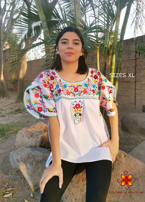 Beautiful blouse made by hand in Chiapas, Mexico creating fashion and art. This is a beautiful blouse with colorful flowers and short sleeve. Very comfortable, Goes great with jeans, leggings, skirt, shorts... Each piece is unique and handmade with dedication and taking care of every detail achieving the best quality in our products, which is why it makes it beautiful and unique each of the embroidered flowers. You can buy the set of blouse with earrings. Size medium 1 Shoulder: 18-19 inches 2 B Mexican Flower Shirt, Mexican Embroidered Blouse, 70s Fancy Dress, Mexican Shirt, Comfortable Blouses, Mexican Shirts, Mexican Blouse, Mexican Outfit, Skirt Shorts