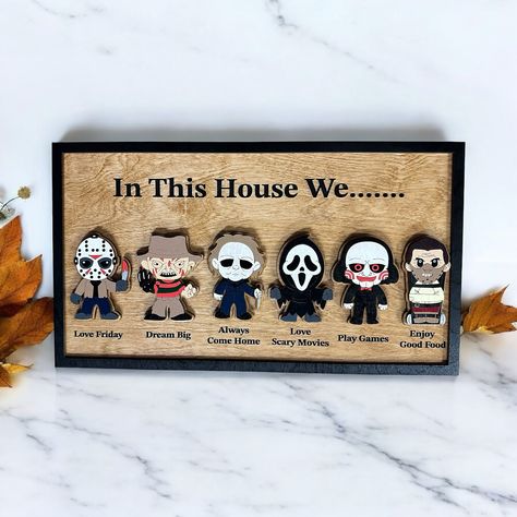 Introducing the perfect addition to your Halloween-themed decor: the “In this house we...” sign featuring a collection of iconic horror characters. Each character is paired with a unique phrase to capture the essence of your household’s interests and passions. From “love Friday” to “dream big,” “love scary movies,” “play games,” and “enjoy good food,” this sign embodies a blend of spooky fun and everyday delights. Whether you’re a horror enthusiast or simply enjoy a good scare, this sign is s... Horror Halloween, In This House We, In This House, Themed Decor, Horror Characters, Play Games, Halloween Horror, Big Love, Scary Movies