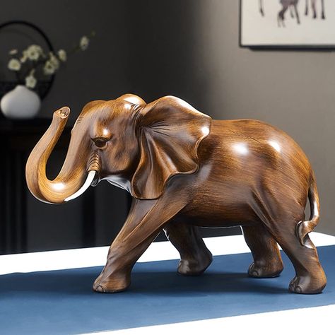 PRICES MAY VARY. -Elegant Elephant Statues — The lovely elephant statues are the perfect way to add warmth and beauty to your home décor with beautiful wood finishes and breathtakingly intricate details – making any space even more refined and charming! -Handcrafted from high quality resin — Handcrafted from resin material with a vintage finish wood grain, this elephant sculpture will provide the perfect sense of beauty and luxury in any space it is placed in! -Stylish elephant feng shui — adds Figurine, Feng Shui Decoration, Rosewood Color, Unique Flower Vases, Ceramic Sculpture Figurative, Elephant Carving, Clothes Organization Diy, Wooden Elephant, Wood Statues