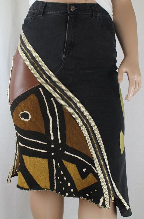 "Handcrafted One-Of-A-Kind Upcycle jean skirt This Lucy Roots Denim handcrafted one-of-a-kind upcycle jean skirt, is a striking piece of Afrocentric apparel that embodies the essence of Black culture clothing and Diasporic fashion. Constructed from thrifted jeans, this plus size pencil skirt is pieced with African Mud Cloth and genuine leather. Decorative gold & white braided trim add depth and texture. Featuring a shimmering 19\" Gold Vinyl Ankh applique that pays homage to African heritage fashion with its ancient Egyptian symbolism of life. Function meets style with front and side seam metal zippers so you can choose to be modest....or not. All seams and raw edge hem are serge finished for durability and quality craftsmanship. Included with the skirt is a one yard cut piece of a coordin Upcycling, Couture, Upcycle Jeans Skirt, Thrifted Jeans, Plus Size Pencil Skirt, Mode Hippie, Culture Clothing, Diy Vetement, Upcycle Jeans