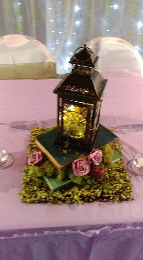 Enchanted Forest Favors Diy, Enchanted Fairy Centerpieces, Books And Lantern Centerpieces, Thrift Centerpiece Wedding Ideas, Enchanted Forest Lantern Centerpieces, Fairy Tail Wedding Decoration, Enchanted Forest Sweet 16 Cake, Enchanted Forest Centerpiece, Dark Enchanted Forest Theme Quinceanera