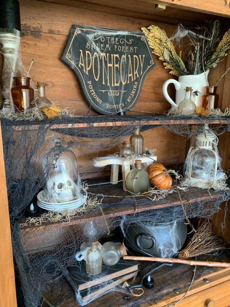 Halloween Decorations Apothecary, Halloween Witch Apothecary, Spooky Apothecary Display, Halloween Kitchen Cabinets, Apothecary Cabinet Halloween, Spooky Apothecary Decor, Halloween Hutch Display, Witches Apothecary Cabinet, Witch Apothecary Halloween