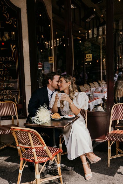 Engagement photoshoot of a couple in Paris at a charming Parisian cafe. Paris Cafe Couple Photoshoot, Paris Cafe Engagement Photos, Romantic Food Photography, Pre Wedding Cafe Shoot, Pre Wedding Photoshoot Cafe, French Cafe Photoshoot, Pre Wedding Shoot In Cafe, Couple Shoot In Cafe, Couples Cafe Photo