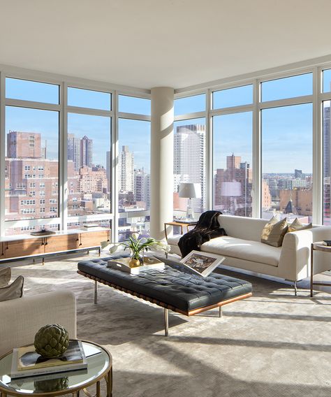 This home features exquisite floor-to-ceiling windows offering breathtaking views of the East River—take a look around! Pictured above, living room. High Rise Apartment Living Room, Apartamento New York, New York Penthouse, Apartment View, Luxury Penthouse, Condo Living, New York Apartment, Dream Apartment, City Apartment