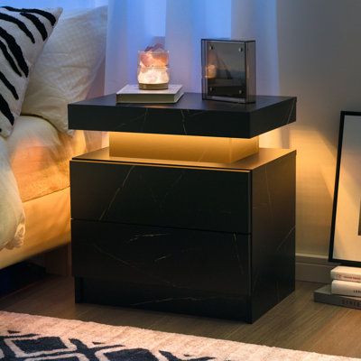 Specification: Product name: LED Beside the table. Material: MDF, LED light. Color: White. Weight Capacity: 66lb. Product Size: 19.3*13.7*20.5 in. Package Included: 1Pcs*LED beside table, 1pcs*instruction. Color: Black Marble | Ivy Bronx Bedside Table w / 2 Drawers, Led Nightstand Wooden Cabinet Unit w / Led Lights For Bedroom | 20.5 H x 19.3 W x 13.7 D in | Wayfair White Nightstand Black Bedframe, Bed Stands Bedside Tables, Men Bedside Table, Men Apartment Decor Bedroom, Bed Side Table Black, House Decor Men, Bed Stand Ideas, Cool Room Decor For Guys, Night Stand Ideas Decor