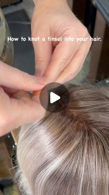 WhiteRock " Master Hairstylist" on Instagram: "“Add a touch of sparkle to your hair with this easy tinsel knot technique! ✨ 

Tinsel installation steps:

1.	Take one tinsel and fold it in half.
2.	Create a loop and pull one strand of hair through the loop. Use a very small strand of hair, maybe three single hairs.
3.	Make a knot between the hair and the tinsel.
4.	Take the two tinsel strands and do two double knots.

And that’s it!

“Please follow, like, save, and share if you love this look! Your support means the world to us. ❤️🙏”

#tinselhair #hairtutorial #hairhowto #whiterockhaircut #whiterockbchairstylist #hairsparkle #hairaccessories #funhair #hairfashion #hairstyles #stardustmagic #hairtinsels" Tinsel In Light Brown Hair, How To Tie Hair Tinsel In Hair, How To Put Hair Tinsel In Hair, Tinsels In Brown Hair, Hair Tinsel Slip Knot, How To Do Hair Tensil, How To Put Tensile In Your Hair, How Do You Put Tinsel In Your Hair, Hair Shimmer Strands