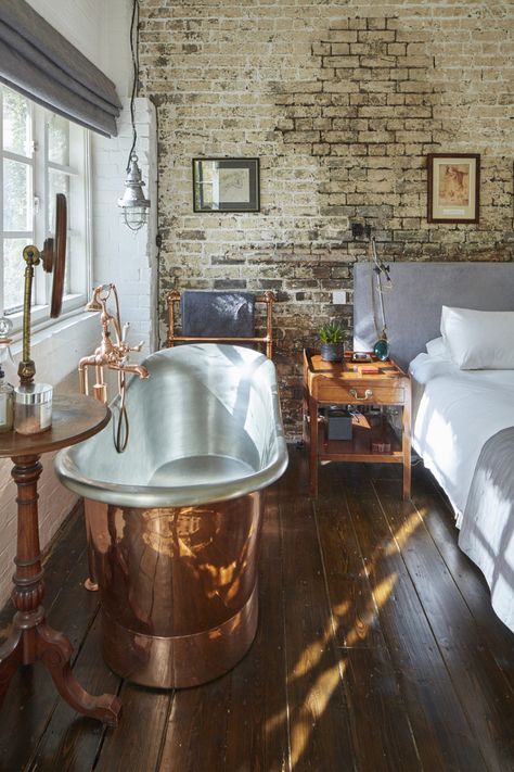 For Sale: The Printing House, London N1 | The Modern House The Holiday Cottage, Copper Bathtub, Exposed Brick Wall, Retro Signage, Natural Swimming Ponds, Cosy Bedroom, The Modern House, Thatched Roof, Barn Conversion