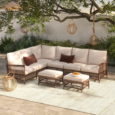 The perfect addition to any patio, deck, or sunroom, this all-weather wicker 6-person sectional seating set is made from durable, weather-resistant wicker and features plush, comfortable cushions. The set includes a sectional sofa and two ottomans. The modular design allows you to arrange the pieces in a variety of configurations to suit your needs. | Ebern Designs Direnzo 98" Wide Outdoor 6 - Person Outdoor Wicker L-Shaped Patio Sectional w / Cushions Wicker / Rattan in Brown | 32.7 H x 98 W x Rattan Sectional Sofa, L Shape Outdoor Sofa, Outdoor Couches Patio, Cute Outdoor Furniture, Small Deck Patio Furniture, Outdoor L Shaped Bench, Front Porch Sectional, Modern Farmhouse Patio Furniture, L Shaped Outdoor Couch