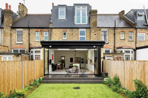 A single-storey rear extension to this terraced house in Wimbledon has created an open-plan kitchen-living-diner. Planning permission was sought for a 4m-long design with bi-fold doors and skylights. | #homedesign #interiorinspo #renovation #homedecorideas #dreamhome #homeremodel #interiordesign #kitchenextension #singlestorey #kitchenextensions #kitcheninspo #dreamkitchen #kitchendecor #crittallstyle #crittalldoor #glazing #storageideas #stoarge #kitchenstorage #kbbmag Terraced House Kitchen Extension, Extension Ideas Open Plan, Victorian Terrace Kitchen Extension, Terrace Kitchen Extension, Terrace House Kitchen, Terraced House Kitchen, Victorian Terrace Kitchen, Rear Kitchen Extension, Wraparound Extension