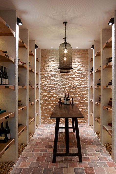 Hanging lamps with netted shades give the wine cellar a charasmatic light.  [i][b]Like this? You might also like [link url="http://www.houseandgarden.co.uk/interiors/real-homes/chateau-de-sully-burgundy"]A Renaissance Château With a Fairytale Story[/link] [/b][/i] Stone Wine Cellar, Cellar Inspiration, Wine Cellar Inspiration, Wine Cellar Ideas, Cellar Ideas, Wine Cellar Basement, Wine Closet, Wine Cave, Home Wine Cellars