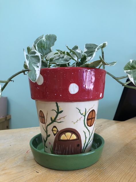 Gnome home style plant pot #potterypainting #ceramcs #paintyourownpottery #flowerpot #paintingideas Painting Ideas On A Pot, Cute Clay Pot Painting Ideas, Drawing On Plant Pot, Drawing On Pots Ideas, Fairy House Pottery Painting, Succulent Pot Ideas Paint, Plastic Vase Painting Ideas, Pottery Planter Painting Ideas, Custom Plant Pot