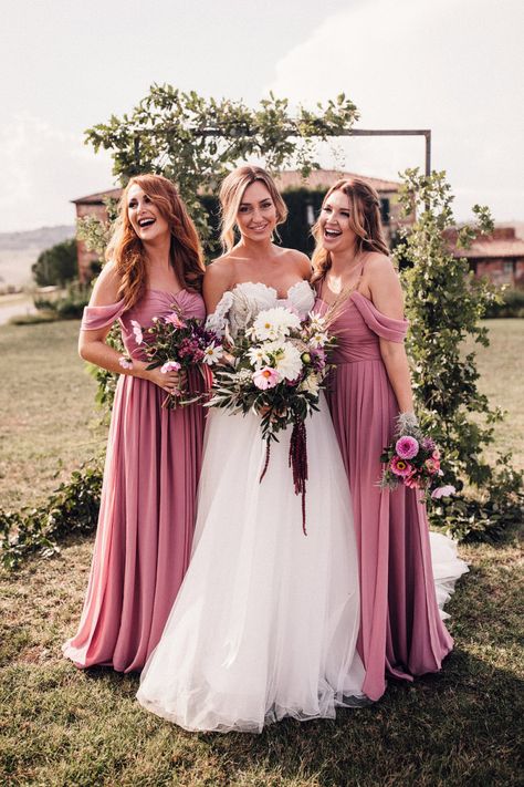 Bride in Structured Bustier Rue de Seine Fox Gown with Floral Appliqué Detail and Off The Shoulder Straps | Pronovias Chiffon Overskirt | Pink, Purple and White Wildflower Bouquet with White Trailing Ribbon | Bridesmaids in Dusky Pink ASOS Dresses with Ruched Bodice and Off-Shoulder Straps | Wooden Wedding Arch with Botanicals | Il Rigo Agriturismo | Rue de Seine Wedding Dress with Pronovias Overskirt, Personalised Place Setting Illustrations and Sweetheart Table | Samuel Docker Photography Dusky Pink Bridesmaid Dresses, Dusky Pink Bridesmaids, Dusky Pink Dress, Blue Bridesmaid Dresses Short, Rue De Seine Wedding Dress, Dusty Pink Bridesmaid Dresses, Blush Pink Bridesmaid Dresses, Indian Bridesmaid Dresses, Pink Bridesmaid Dress