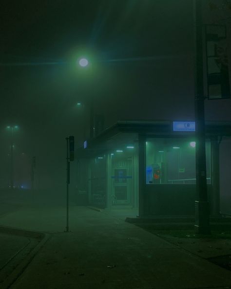 This shows a bus stop that’s lit in an eerie green foggy way. Foggy Nights Aesthetic, Green Foggy Aesthetic, Dark Foggy Aesthetic City, Dark City Photography, Foggy Green Aesthetic, Foggy City Night, Foggy Liminal Space, Foggy Night City, Foggy Aesthetic City