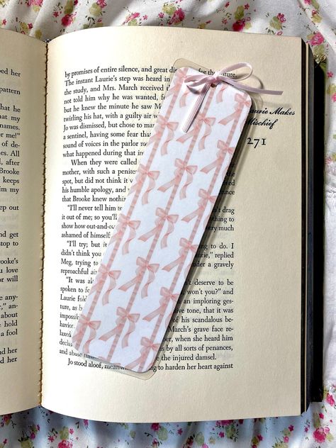 "the sweetest bookmark, featuring dainty coquette pink bows <3 *made with laminated heavyweight cardstock *shipped in protective plastic sleeve *measures approx. 2\" x 7\" *all bookmarks come with a pink bow *colors may vary depending on screen displays. please allow for slight variations between on-screen photographs and physical prints. *if you're interested in more than one bookmark in my shop, I offer a bundle discount on orders of any three of your choice! look for the \"collections\" tab on my page :) completely handmade and designed by olivia lukes. made to order and shipped from austin, TX. all sales are final and non-refundable. please contact me if you have any issues with your order via etsy messages @livslovenotes. i want to make sure you love your order!" Coquette Bookmark, Book Marks Design Ideas, Bow Bookmark, Pinterest Wishlist, Dainty Coquette, Pink Bookmark, Reading Essentials, Cute Bookmark, Bookmark Ideas