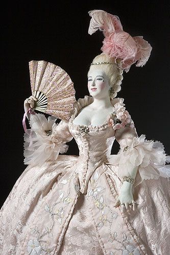 This wax figure Madame du Barry, official mistress of Louis XV, exemplifies the extent of frivolity of dress during the period. She was known for her white skin and palest blonde hair, seen here enhanced by white powders, and was a major trend-setter for her incredible beauty and status. Note the ornate plumage in her hair and the extreme flounces at her sleeves, the edges of which would not have been hemmed as this would hamper the delicate lace but cut in a scallop or Van Dyke pattern. Madame Du Barry, Istoria Modei, 1700 Fashion, Marie Antionette, Rococo Fashion, Century Dress, Period Dress, 18th Century Fashion, Old Dresses