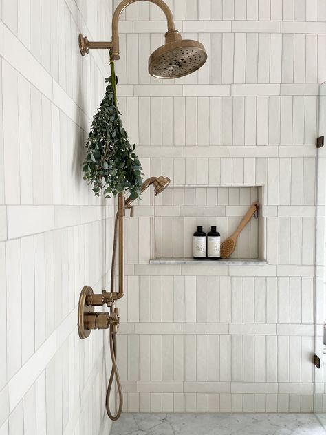 White vertical shower tiles with brass shower head and marblw accents by Laura Design and Co, Dallas interior designer Farmhouse Luxury Bathroom, Tiled Bathroom, Shoji White, Amazing Showers, Coastal Bathroom, Master Bath Remodel, Hus Inspiration, Bathroom Redo, House Bathroom