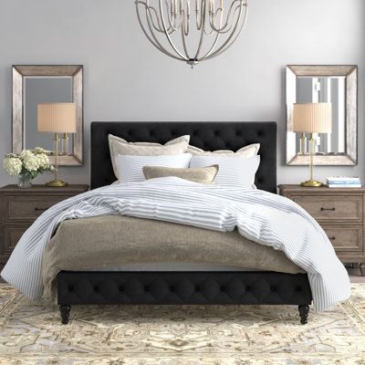 This standard bed includes classic accents that stand out and a low profile to make your bedroom appear larger. It's made from engineered wood, and it rests on turned front legs for a traditional touch. Wrapped in velvet for a luxe look, this bed also features a rectangular panel headboard with a scrolled top and button tufting. It's filled with foam for just the right amount of cushion as you enjoy your favorite show before bed. Nailhead trim rounds out this sleek design. Center slats support a Black Tufted Headboard Bedroom, Black Tufted Headboard, Black Headboard Bedroom, Black Upholstered Bed, Tufted Headboard Bedroom, Rooms Decorations, Aesthetics Room, Idea Bedroom, Lights Room