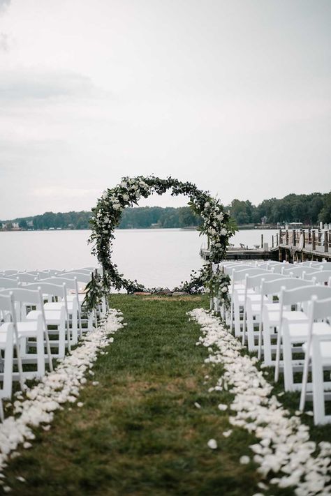 This Summer Lake wedding was intimate and romantic. Elements of the lake were on the custom stationery, as well as the details of the wedding. Neutral florals made for a bright and beautiful waterfront ceremony area that was the highlight of their wedding day. See more from this lake wedding at https://annahowedesign.com/tiffany-connor/ Outdoor Waterfront Wedding, Wedding By The Lake Outdoor Ceremony, Wedding On The Water Ideas, By The Lake Wedding, Lake Wedding Backdrop, Lake Wedding Florals, October Lake Wedding, Weddings By The Lake, Wedding On A Lake Ideas