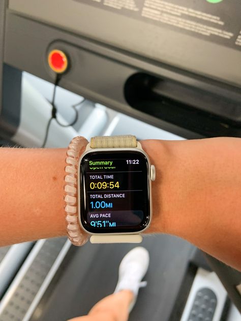 Person in the picture is on the treadmill with an Apple Watch on wrist showing time it took to run a mile. There is also a hair tie on the wrist next to the watch. Apple Watch Steps Aesthetic, Apple Watch Rings Closed Aesthetic, Apple Watch Running Aesthetic, Apple Watch Fitness Aesthetic, Apple Watch Series 8 Aesthetic, Apple Watch Astethic, Apple Watch Inspiration, Apple Watch Running, Gemini Core