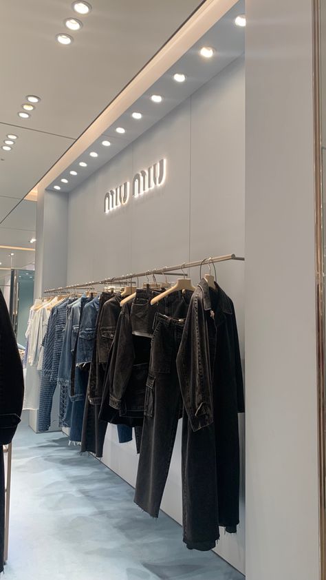 clothing rack with denim clothes in miu miu store Miu Miu Store Aesthetic, Luxury Bridal Boutique Interior, Clothing Store Aesthetic Interior, Luxury Store Aesthetic, Clothing Boutique Aesthetic, Miu Miu Aesthetic Outfit, Boutique Aesthetic Ideas, Dior Store Aesthetic, Clothes Store Aesthetic