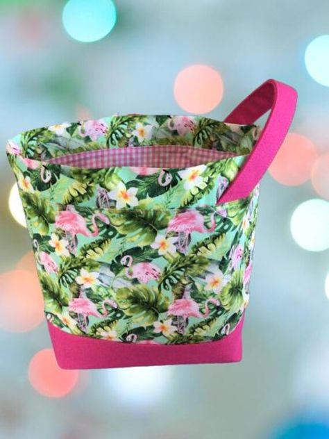 This one-of-a-kind project bag features fun pink flamingo and floral fabric, and is lined with pink gingham.  A small sized project bag that measures approximately 25cm wide, 20cm high and 9cm across the boxed bottom.  This drawstring bag is perfect for your small knitting or crochet projects such as socks, beanies, baby or child sized knitting projects. Pictured here with a pair of  4 ply socks.  It has a boxed, flat bottom which means it will stand while in use and is fully lined with gingham Crochet Bags, Bag Knitting, Gingham Fabric, Yarn Bowl, Project Bag, Pink Gingham, Drawstring Pouch, Interior Fabric, Pink Flamingo