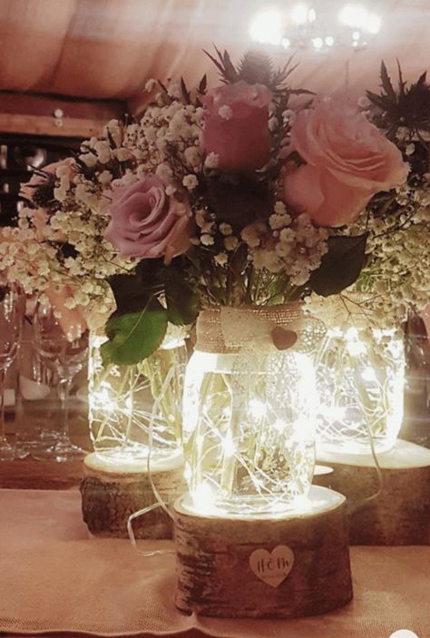 35 Wedding Mason Jar Ideas To DIY (That Everyone Will Love!) Wedding Mason Jar Ideas, Centerpieces For Quinceanera, Lighted Wedding Centerpieces, Jar Wedding Centerpieces, Mason Jar Wedding Centerpieces, Wedding Table Decorations Pink, Mason Jar Center, Tinted Mason Jars, Spring Wedding Centerpieces