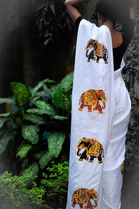 Bright white saree with elegant decorative elephant motifs hand painted with fabric paint on cotton silk fabric. Painting On Black Saree, Hand Painted Sari, Saree Fabric Painting Designs, Fabric Painting On Saree, Painting On Saree, Punjabi Art, Thanjavur Painting, Hand Painted Saree, Painted Saree