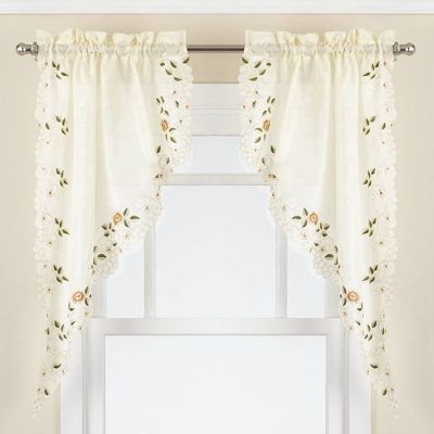 Rosemary kitchen curtain swag is embroidered with a scrolling floral pattern on semi-sheer linen look cloth that melds old-world charm with an updated presentation. The scalloped bottom edge is over-stitched and embellished with embroidery. This set includes 2 Swag Curtains Only. The Bottom Tiers and Valance are sold separately. | Ophelia & Co. Kwame Rosemary 58" Swag Kitchen Curtain Set Polyester in White | 38 H x 29 W in | Wayfair Kitchen Sink Curtains, Curtain Swag, Kitchen Curtains And Valances, Kitchen Window Valances, Round Chair Cushions, Kids Sheet Sets, Dutch Farms, Above Sink, Swag Curtains