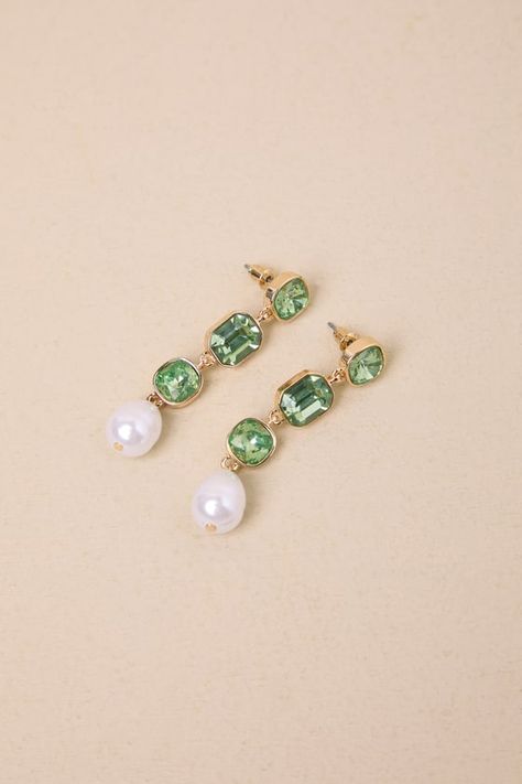 Spend your evenings throwing major sparkle with the Lulus Shiny Spectacle Green and Gold Pearl Drop Earrings! Shiny, gold-toned metal shapes these elegant earrings that have a series of oversized green rhinestones in various shapes, all supporting large dangling faux pearl charms at the ends. Post backs. Earrings measure 2" Long. 50% Zinc, 45% Plastic, 5% Iron. Imported. Lulus | Shiny Spectacle Green and Gold Pearl Drop Earrings. Green And Pearl Earrings, Gold Pearl Drop Earrings, Pearl Trend, Dangle Pearl Earrings, Pearl Drop Earrings Gold, Earrings With Pearls, Pearl Earrings Dangle, Pearl Charms, Green Earrings