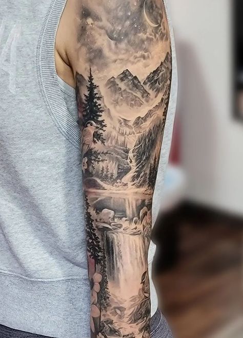 An unbelievably realistic black and grey mountain scenery sleeve tattoo, done by @katarina.heinze. Within this piece is a starry night sky with a crescent moon, trees, a waterfall, rocks, a lake, and of course the rocky peaks of the mountains. Mountain Sleeve Tattoo, Scenic Tattoo, Natur Tattoo Arm, Scenery Tattoo, Lake Tattoo, Cream Tattoo, Arm Sleeve Tattoos For Women, Nature Tattoo Sleeve, Landscape Tattoo