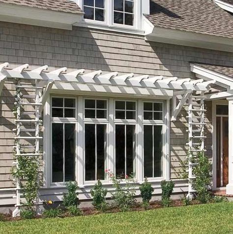 A shallow pergola and trellises give definition to this wall of windows by Marvin. Exterior Window Awnings, Window Arbor, Window Pergolas, Window Trellises, French Casement Windows, Garage Pergola, Exterior Window, Cheap Pergola, Casa Patio