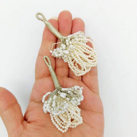 This listing is for Beautiful and one of a kind White Handmade Bugle Beaded Tassel, Bell Tassel, Sari Blouse Latkan, Decorative Tassels, Sewing Latkan 1 Pair, Pearl Tassel. Handmade Measurements: End to End: Approx. 6.5 cm This stunner can be used for any of the following:  *Dress Design: Wedding Dresses, Festive Wear, Ethnic wear *Saree Embellishments, Blouse Embellishments, Salwar Kameez Embellishments *Tops, Dress *Home Decor *Pillow Covers, Cushion Covers, Ottoman decoration *Bag Embellishme Beaded Tassels Diy, Blouse Latkan, Designer Tassels, Saree Tassels Designs, Decorative Tassels, Saree Tassels, Tops Dress, Beading Netting, Diy Tassel