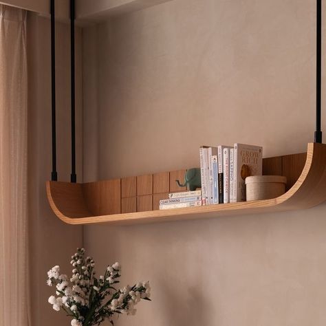 Studio Ipsa | Interior Design Studio on Instagram: "When reading desks are a requirement, we work a charm like this 😍  Just like the rest of the room, we kept the table minimal yet added bespoke legs that make a statement ❤️   Aligning the base to the curves used throughout the home, we created this masterpiece.   A ceiling hung shelf completes the set up in perfect usability and aesthetics 🥰 . Photo credit: @nayansoni21  . . #studioipsa #workstation #studydesk #interiordesign #interiordesignideas #texturepaint #interiordesigninspiration #interiorinspiration" Study Table Shelf Ideas, Curved Shelf Design, Curved Bedroom Design, Shelf Designs For Bedroom, Curved Furniture Interior Design, Complete Home Interior Design, Study Table Shelf, Work Station Design, Bedroom Study Table Design