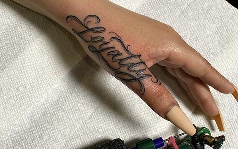 Side Hand Word Tattoos, Hand Tattoos Loyalty, Baddie Word Tattoos, Loyalty Hand Tattoo, Hand Name Tattoos For Women, Word Hand Tattoos For Women, Loyalty Tattoo For Women Ideas, Hand Tattoo Name, Side Hand Tattoos For Women Words