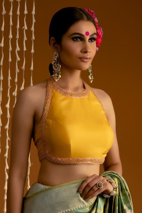 Yellow pure silk blouse with halter neck, multi color thread and sequin embroidered borders. Components: 1 Pattern: Embroidered Type Of Work: Thread and Sequin Work Neckline: Halter Neck Sleeve Type: Sleeveless Fabric: Pure Silk Color: Yellow Other Details:  Durable and wrinkle resistant Backless blouse Attached lining Closure: Back hook and eye Note: The saree, all the jewellery and hair accessory worn by the model are not being sold Occasion: Destination Wedding,Reception - Aza Fashions Halter Blouse Saree, Halter Blouse Designs, V Neck Saree Blouse, Halter Neck Blouse Design, Sleeveless High Neck Blouse, Halter Neck Blouse, Payal Khandwala, Sleeveless Blouse Saree, Sleeveless Blouse Designs