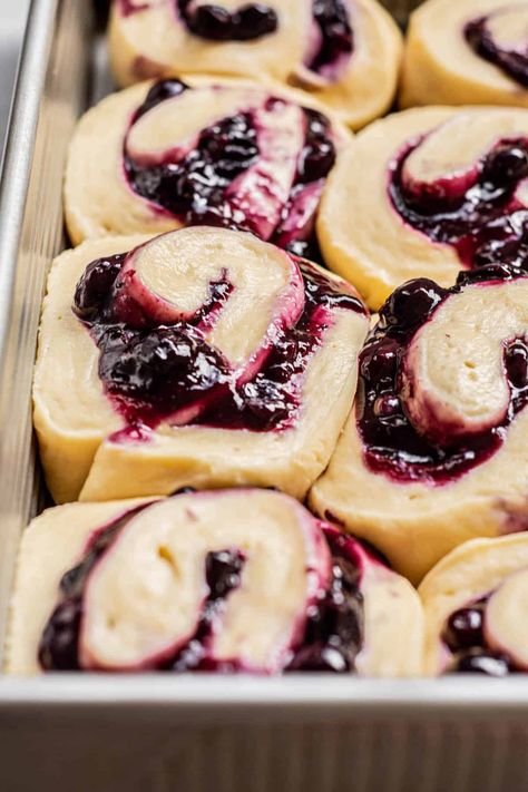 side view of blueberry rolls. Triple Berry Cinnamon Rolls, Brioche, Homemade Blueberry Cinnamon Rolls, Blueberry Sourdough Cinnamon Rolls, Blueberry Cream Cheese Sweet Rolls, Blueberry Cream Cheese Cinnamon Rolls, Blueberry Cinnamon Roll Bake, Blackberry Sweet Rolls, Blueberry Lemon Cinnamon Rolls