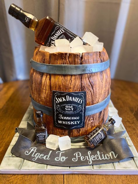 A marble cake wrapped in wood grain fondant, with a real bottle of Jack Daniel’s on top. The cake board and ribbon are fondant as well, and the label is edible! Kraken Rum Cake, Jack Daniels Torte, Whiskey Barrel Cake, Beer Bottle Cake, 30th Birthday Cakes For Men, Jack Daniels Cake, Birthday Beer Cake, Cake Design For Men, Alcohol Cake