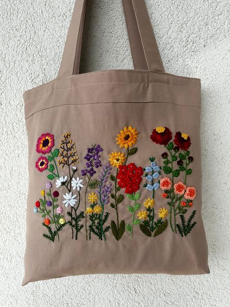 Hello!Welcome to my shop.It's Nursel.☺️ I produce unique handmade bags from Turkey for you and your loved ones all over the world.💝 All of my products are completely handmade. From the embroidery to the bag,they are all made by me.🪡 🌸Details of your bag; *Width:38 cm. *Height:38 cm. *Bag Base Width:6 cm. *Bag Handle Lenght:61 cm. *Bag Material:Duck Linen *Bag Embroidery Material:DMC Embroidery Yarn *Lining Material:Poplin Fabric *There is 1 pocket inside the bag. This bag you see,it is just one of the handmade bags that reflect all the her love from the mother on the one side of the world.🌏❤️ Please review my store to see other items in my store.🏡 You can also come across different models that you may like very much.💕If you want to see different variants of this product,check out my Hand Embroidered Bag, Embroidery Bags Handmade, Cary Bag, Simple Hand Embroidery Patterns, Embroidery Yarn, Embroidered Bags, Bag Embroidery, Floral Tote Bag, Dmc Embroidery