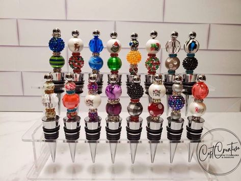 Display your wine stoppers with this clear acrylic stand.  Whether you are a collector or a crafter that wants to showcase your stoppers, this will show off their beauty! 2 options available - 2 Tier and 3 Tier.  Each stand holds 8 per level by default.  If you have wider stoppers, I can provide more space between holes (the 3 Tier pictured has 4 holes per level).   The 2 tier measures 9.1 inches wide x 3.5 inches deep x 4.3 inches high.  The 3 tier measures 9.1 inches wide, 5.25 inches deep, an Wine Bottle Stopper Display, Wine Stopper Diy, Wine Bottle Display, Vendor Table, Bottle Display, Acrylic Shapes, Dragonfly Art, Acrylic Stand, Beadable Products